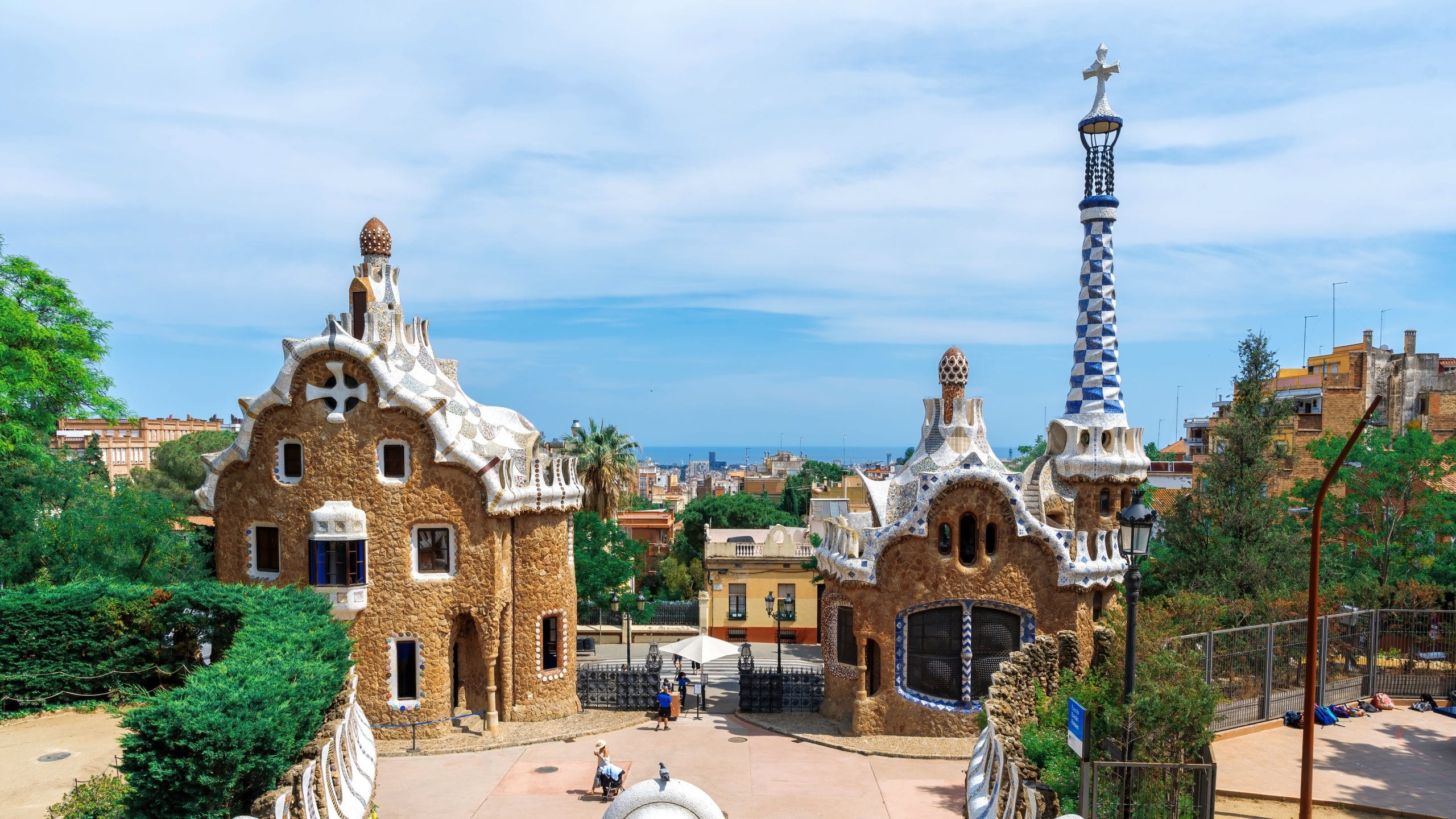 BARCELONA, SPAIN - JUNE 12, 2021: Parc Guel, buildings with unusual architectural style, cityscape on the background