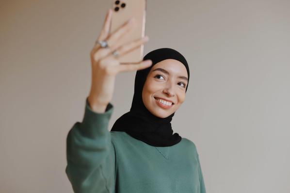A woman taking a selfie as an image of an influencer on social media