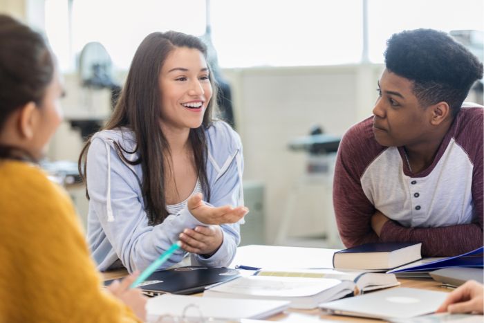 a group of students debating over a topic in class

